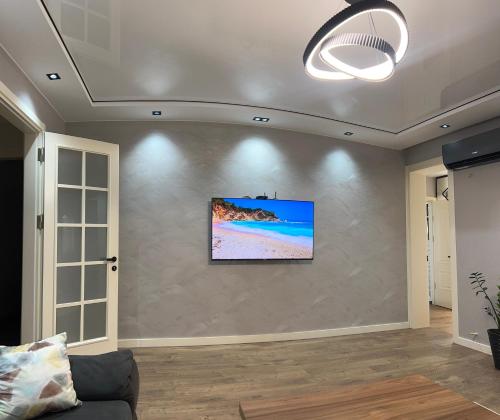 a living room with a tv on a wall at Sunny Escape in Gonio in Gonio