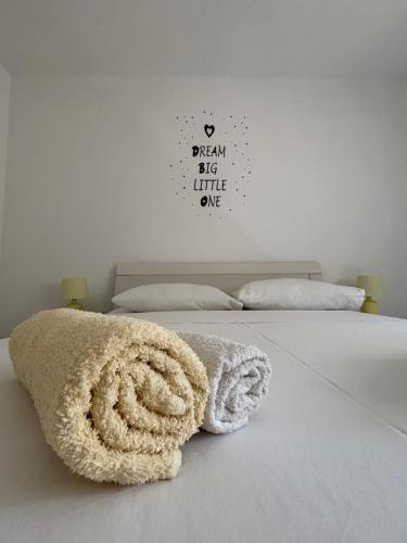 a bedroom with a white bed with towels on it at NEW Apartment Ema II in Vrh