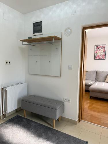 a living room with a bench and a couch at Kuća za odmor Saturnus in Karanac