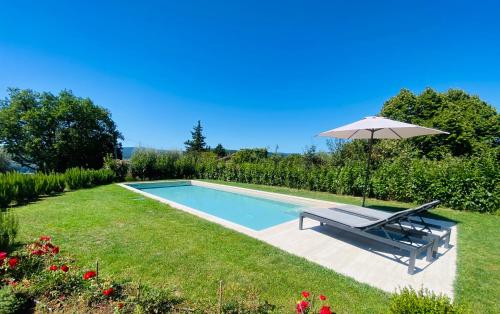 a swimming pool with a bench and an umbrella at Villa Angela - Ranza 55 in Lugnano