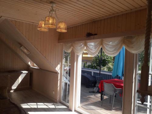 a screened in porch with a table and chairs at Apartment Nautilus in Jūrmala