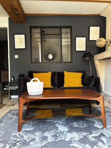 a living room with a couch with yellow pillows at Appartement Talmont sur Gironde in Talmont