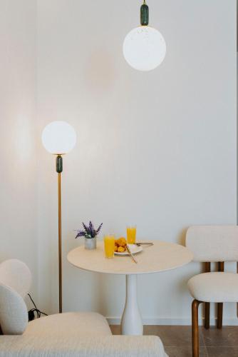a table with two drinks and a lamp at Volaka Luxury Suites in Kos Town