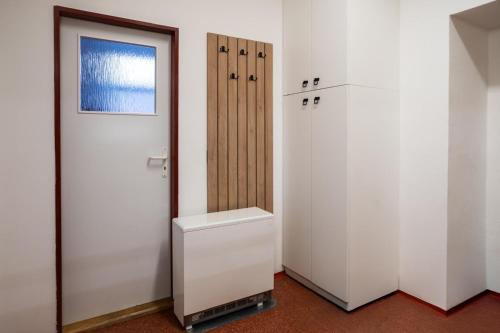 a bathroom with a toilet and a door at Turistický apartmán in Šonov