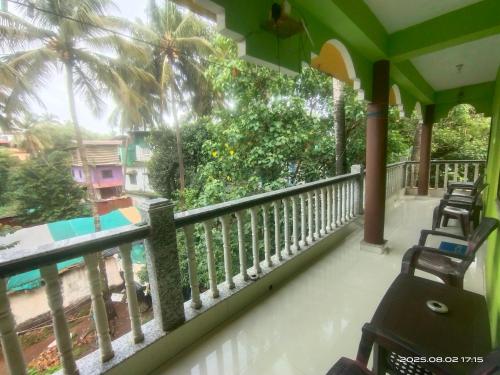 a balcony of a house with a view of a yard at INDRA'S NEST - Studio Apartments Previously No Name Guest House in Arambol