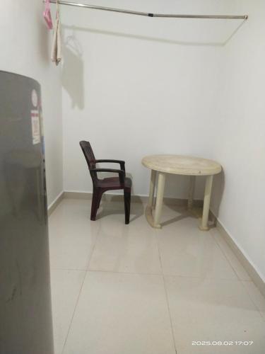 a table and a chair in a room at INDRA'S NEST - Studio Apartments Previously No Name Guest House in Arambol