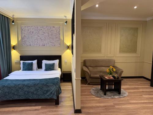 a hotel room with a bed and a chair at Vitrage Hotel Baku in Baku