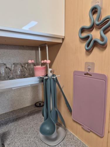 a kitchen counter with a sink with a mirror at Hongdae Home Sweet Home in Seoul