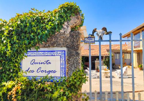 a sign on a fence in front of a building at Quinta dos Corgos in Tábua