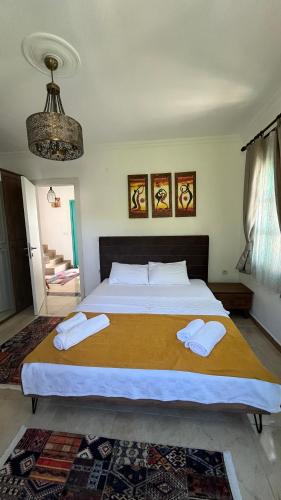 a bedroom with a large bed with two white pillows at Castello Marmaris Holiday Home in Marmaris