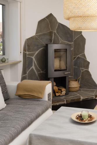 a living room with a couch and a fireplace at Grünten-Blick Apartment in Sonthofen