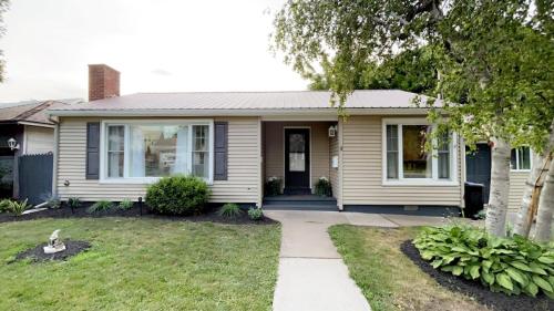 a white house with a porch and a driveway at Home in the Heart of Alex Bay Near Boldt Castle! in Alexandria Bay