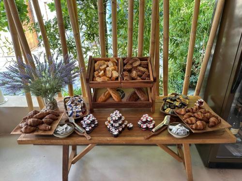 a table full of different types of pastries and desserts at Folie Marine Hotel & Beach Club in Jal