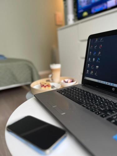 a laptop computer sitting on top of a desk at Apartament Piaskowa Mountain & Coffee in Wałbrzych