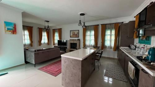 a large kitchen and living room with a couch at Castello Marmaris Holiday Home in Marmaris