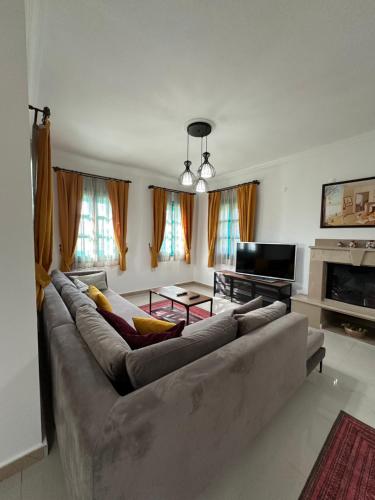 a living room with a couch and a television at Castello Marmaris Holiday Home in Marmaris