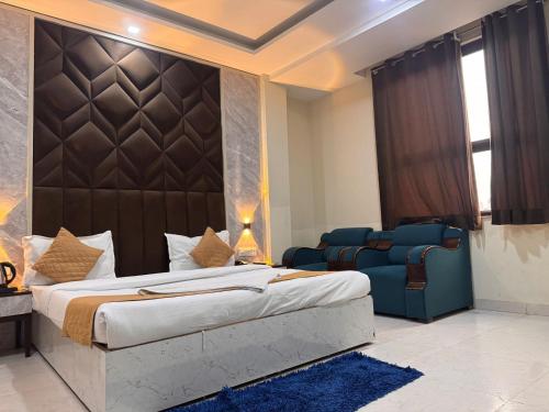 a hotel room with a bed and a couch at Hotel Luxury Villas Near IGI Delhi Airport in New Delhi