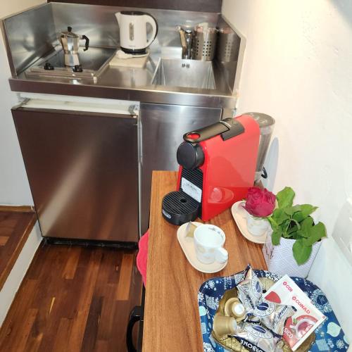 a small kitchen with a coffee maker on a table at Appartamento Girasole in Florence