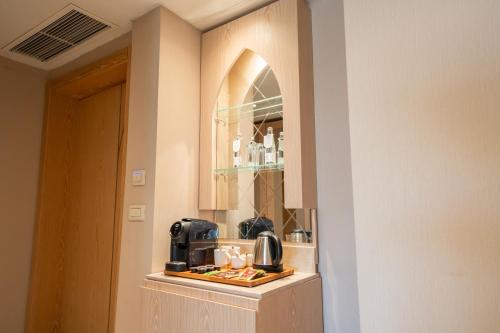 a kitchen with a coffee maker on a counter at World Heart Hotel in Baghdad