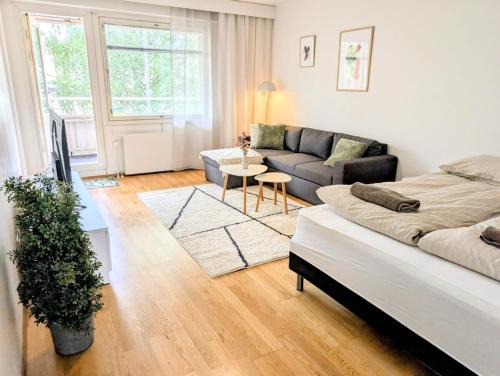 a living room with a couch and a table at Nice and cozy city apartment, free parking in Kemi