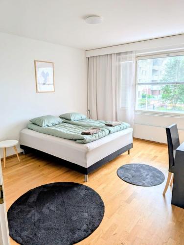 a bedroom with a bed and a window at Nice and cozy city apartment, free parking in Kemi