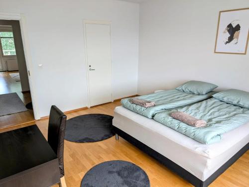 a bedroom with a bed and a desk and a table at Nice and cozy city apartment, free parking in Kemi