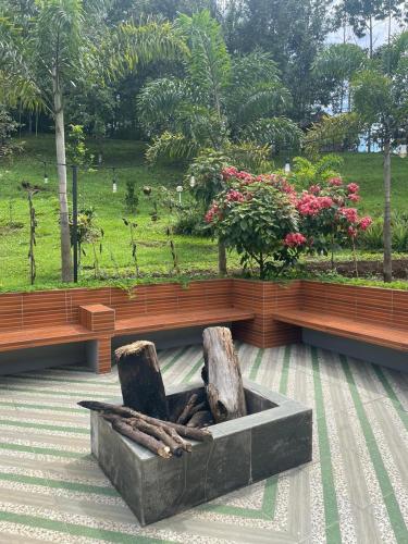 a bench with two chairs sitting on top at The Siburians Garden in Woloan