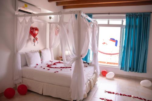 a bedroom with a bed with a red heart on it at hotel 3 banderas Manzanillo del Mar in Cartagena de Indias