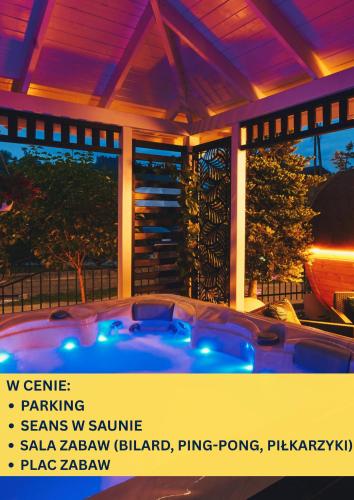 a hot tub in front of a house at night at GORSKI RESORT Lux Apartments Jacuzzi & Sauna in Poronin
