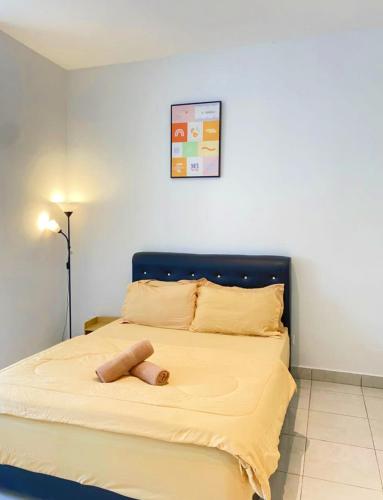 a bedroom with a large bed with a blue headboard at Studio with Rooftop Pool at Youth City Nilai by D'KAY HOMES, near USIM KLIA in Nilai