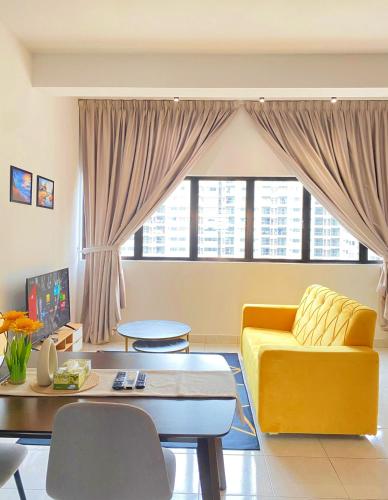 a living room with a yellow couch and a table at Studio with Rooftop Pool at Youth City Nilai by D'KAY HOMES, near USIM KLIA in Nilai
