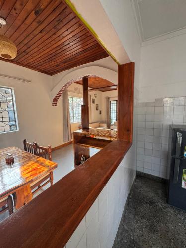 a kitchen with a counter and a table in a room at Arusha backpackers homes in Arusha