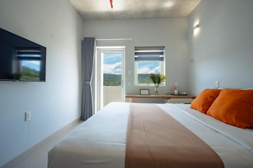 a bedroom with a large bed and a window at The Up Hotel Phu Quoc Island - The Poolside Escape in Phu Quoc