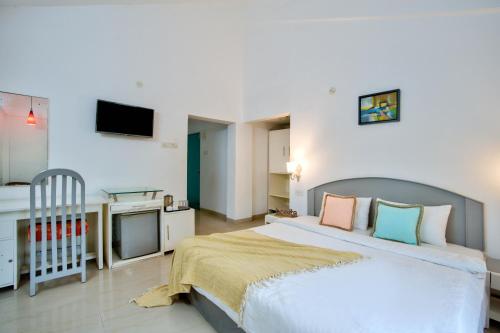 a bedroom with a bed and a crib in it at Hotel69 calangute goa in Saligao