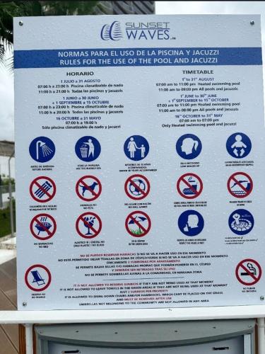 a sign with many different signs on it at SUNSET WAVES blue sky apartment in Benidorm