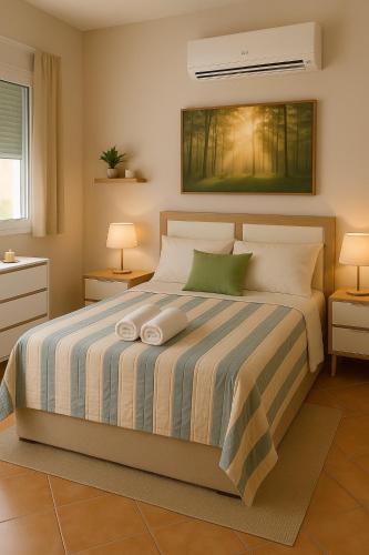 a bedroom with a bed with two pillows on it at Chalet Californiano con Piscina in Morón de la Frontera