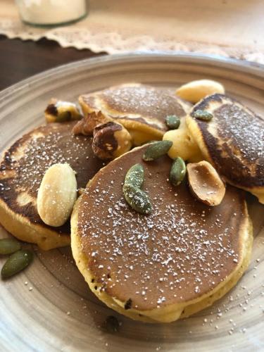 a plate of pancakes with nuts and seeds on it at Agriturismo Malpensata in Radda in Chianti