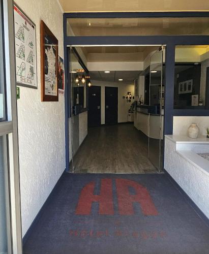an empty hallway with an exit sign in a building at Hôtel Aragon - Centre ville gare in Perpignan