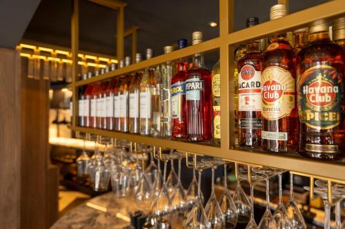 a bar with many bottles of beer and wine glasses at Hotel Indigo Leeds by IHG in Leeds