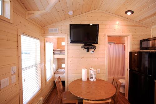 a small dining room with a table in a log cabin at Soledad Canyon Cottage 5 in Ravenna
