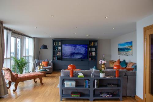 a living room with a couch and a table at Galway Beach Penthouse in Galway