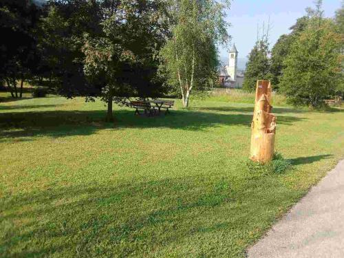 a park with a bench in the grass at A Casa mia in Bieno