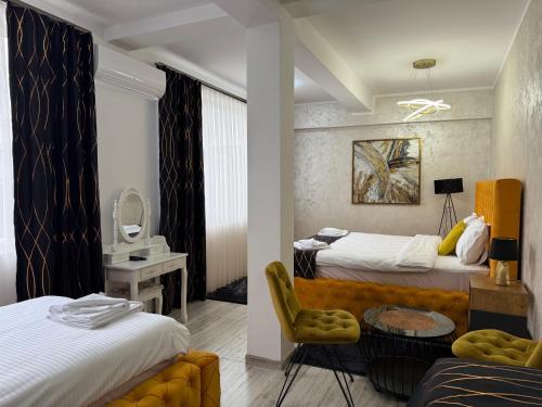 a hotel room with two beds and a chair at Golden Hill Palace in Novi Pazar