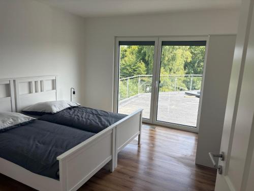 Ένα ή περισσότερα κρεβάτια σε δωμάτιο στο Ferienhaus Kölzer Weg Erdgeschoss mit E-Auto Ladestation