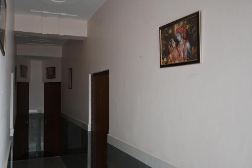 a painting hanging on a wall in a hallway at Shree Jee Hotels in Vrindāvan