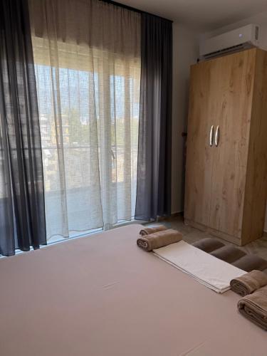 a room with a bed and a large window at Bejart Apartment 7 in Tirana
