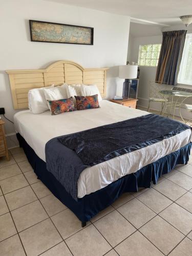 a bedroom with a large bed with pillows on it at Lowes Wharf Marina Inn in Sherwood