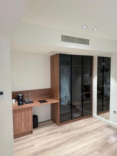 a room with a desk and glass walls at Aeolis Hotel in Samos