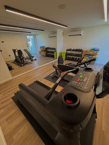 a fitness room with a gym with a treadmill at Aeolis Hotel in Samos
