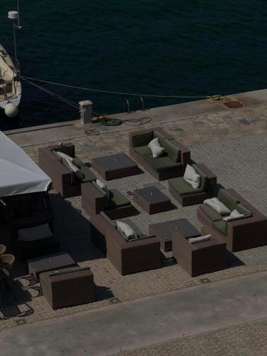 a group of chairs and tables on a boat at Aeolis Hotel in Samos